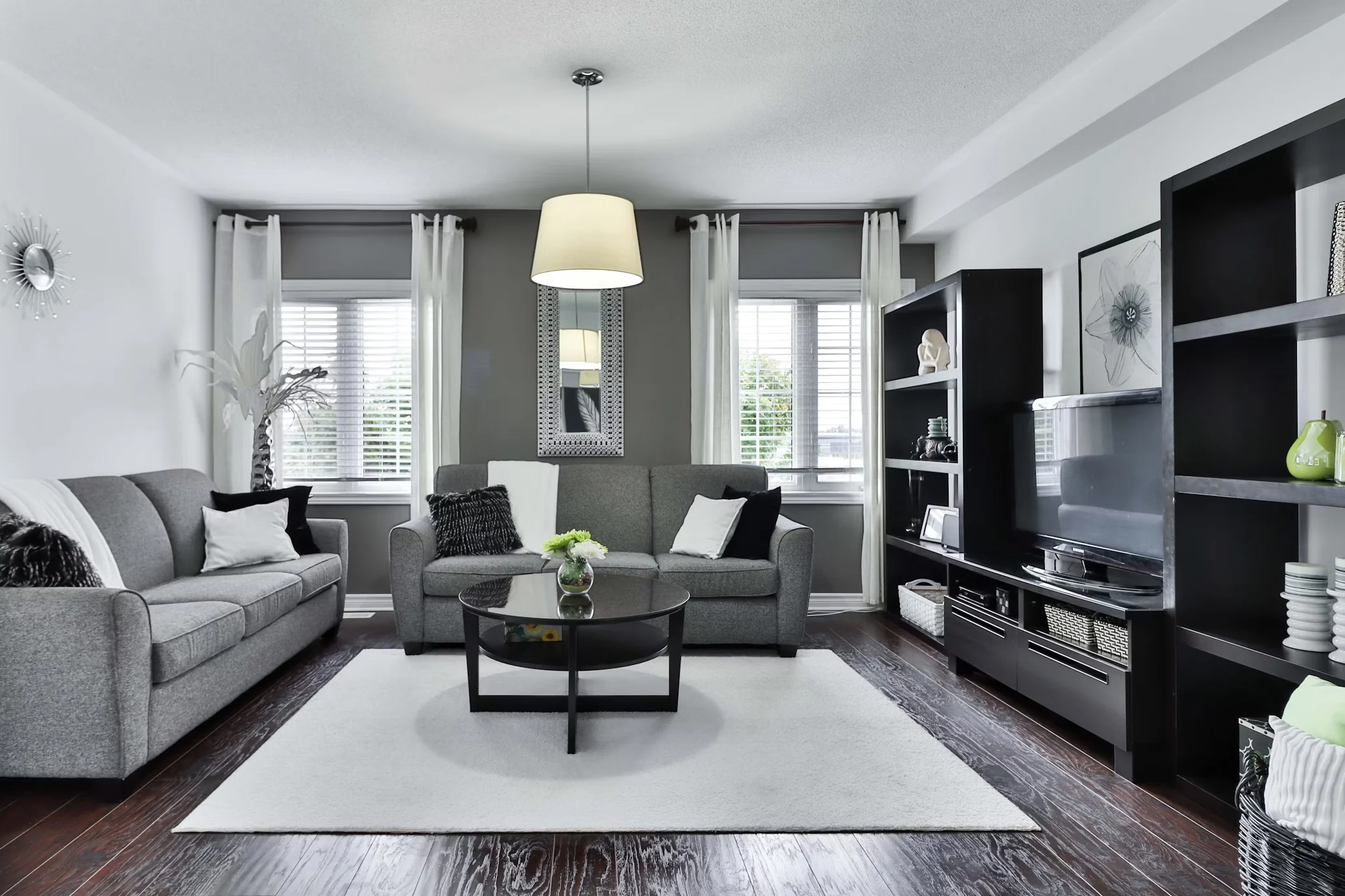 Light grey living room with white trim and dark furnishings